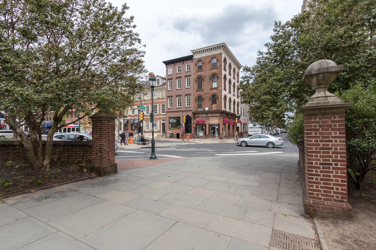 a view of a city street with buildings and a car